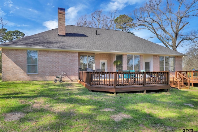 rear view of house with a yard and a wooden deck