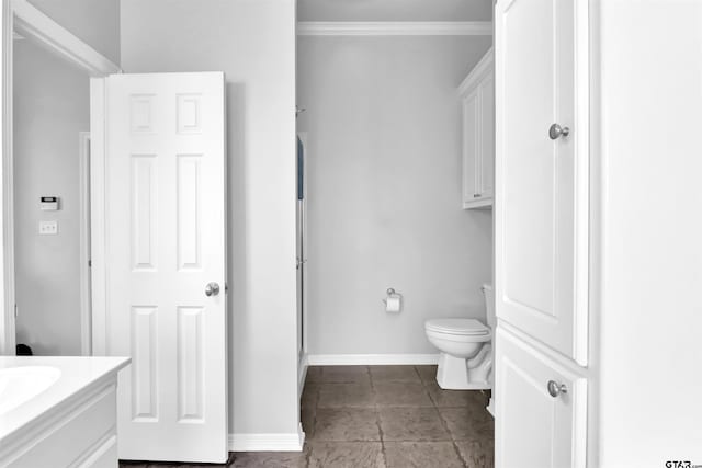 bathroom featuring ornamental molding, vanity, a shower with door, and toilet