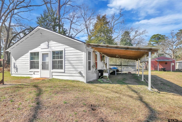 view of side of home featuring a lawn and a carport