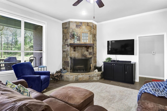 living room featuring tile patterned floors, ceiling fan, crown molding, and a fireplace