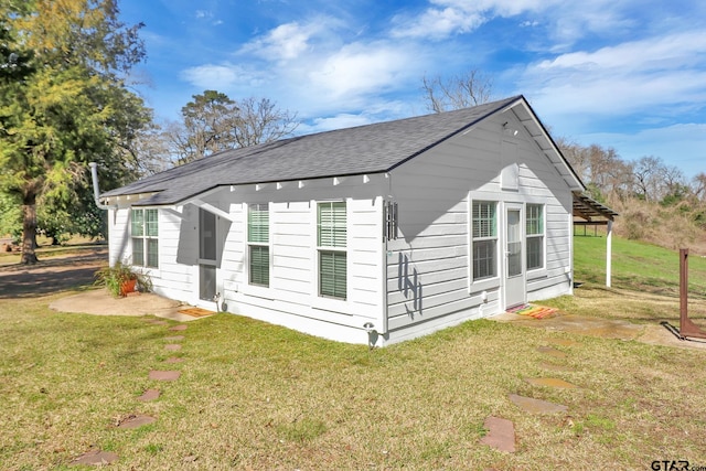 view of property exterior featuring a lawn