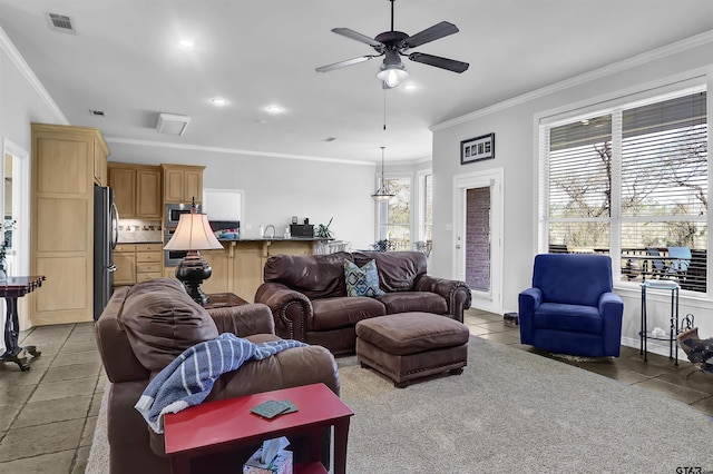 living room featuring ceiling fan, ornamental molding, and tile patterned floors