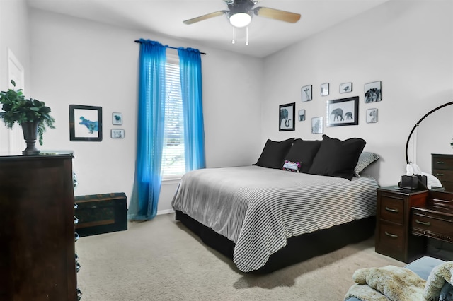 bedroom featuring ceiling fan, multiple windows, and light colored carpet