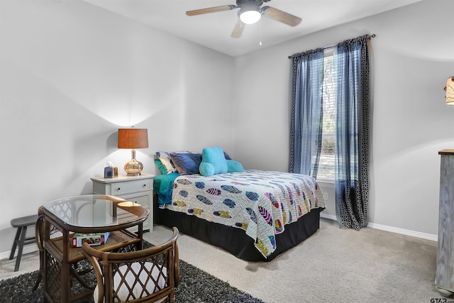 carpeted bedroom with multiple windows and ceiling fan