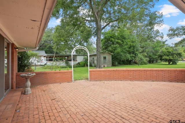 view of patio featuring a shed