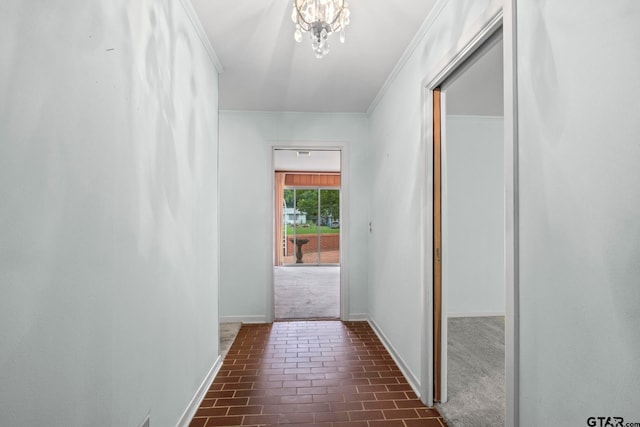 hallway featuring an inviting chandelier and ornamental molding