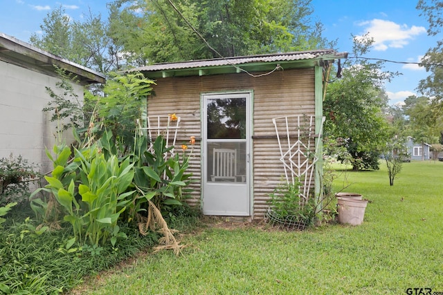 view of outdoor structure featuring a lawn