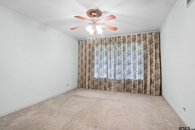 empty room featuring ceiling fan, light carpet, and ornamental molding