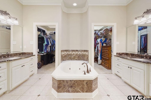302 Coventry St, Bullard, TX 75757 - full bath featuring two vanities, tile patterned flooring, a whirlpool tub, a spacious closet, and ornamental molding