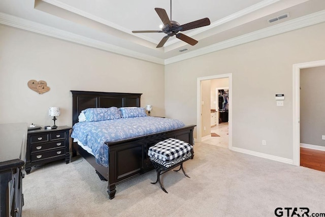 302 Coventry St, Bullard, TX 75757 - bedroom with a tray ceiling, light carpet, ornamental molding, a ceiling fan, and a walk in closet