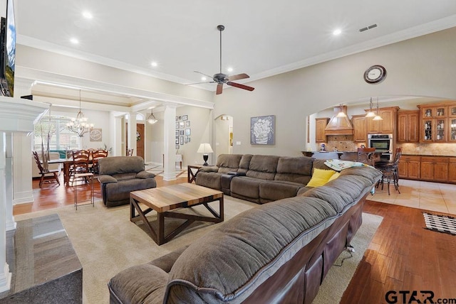 302 Coventry St, Bullard, TX 75757 - living area with arched walkways, recessed lighting, a ceiling fan, a chandelier, and crown molding