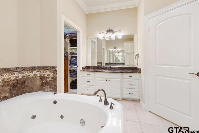 302 Coventry St, Bullard, TX 75757 - bathroom with crown molding, vanity, a whirlpool tub, tile patterned flooring, and a spacious closet