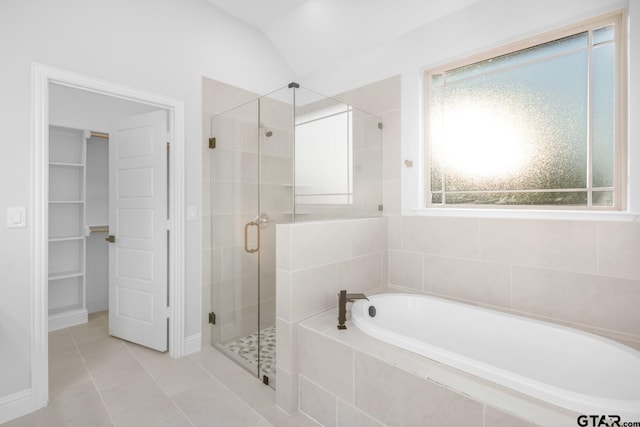 2062 County Road 1612, Alba, TX 75410 - bathroom featuring a bath, a stall shower, tile patterned flooring, lofted ceiling, and a walk in closet
