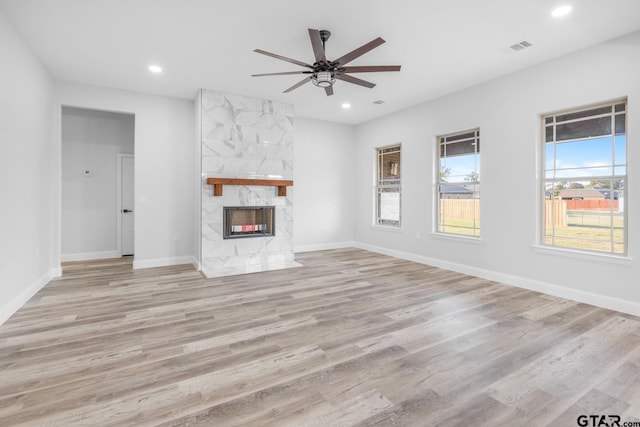 2062 County Road 1612, Alba, TX 75410 - unfurnished living room featuring recessed lighting, ceiling fan, wood finished floors, a high end fireplace, and baseboards