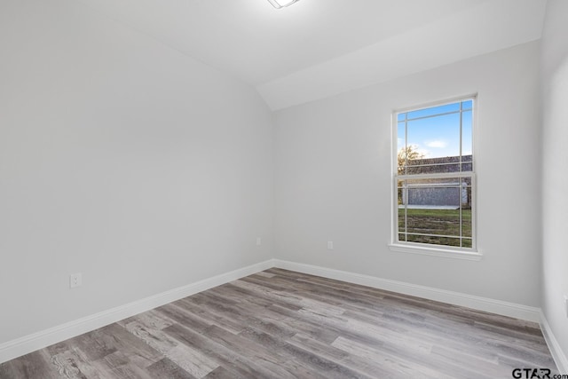 2062 County Road 1612, Alba, TX 75410 - empty room with wood finished floors, baseboards, and lofted ceiling