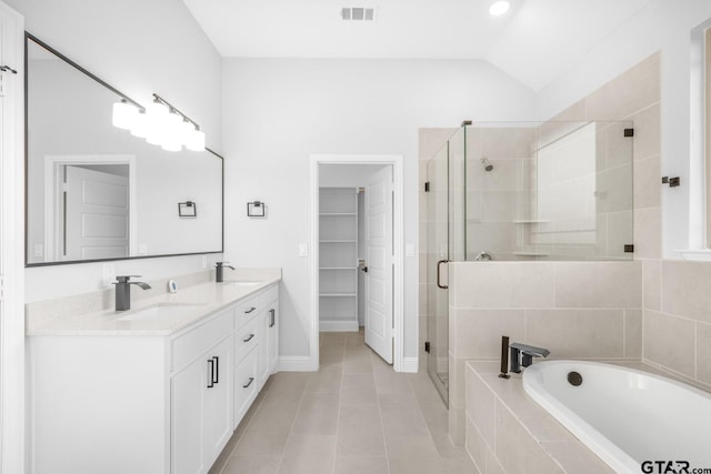 2062 County Road 1612, Alba, TX 75410 - bathroom with a bath, a stall shower, double vanity, tile patterned flooring, and lofted ceiling