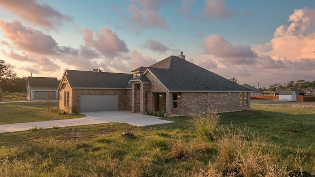 2062 County Road 1612, Alba, TX 75410 - view of front of home with driveway, an attached garage, brick siding, and a yard
