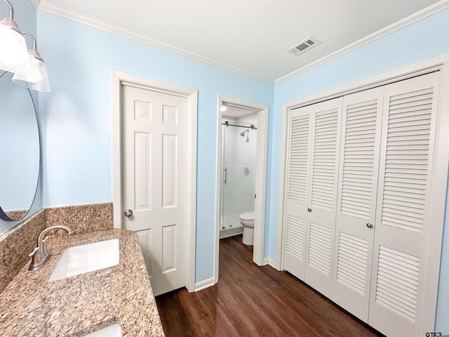 13909 Joe B Fulgham Cir, Brownsboro, TX 75756 - bathroom featuring wood finished floors, a closet, ornamental molding, toilet, and a shower stall