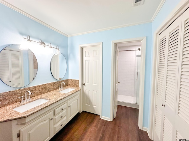 13909 Joe B Fulgham Cir, Brownsboro, TX 75756 - bathroom with a closet, wood finished floors, ornamental molding, double vanity, and baseboards