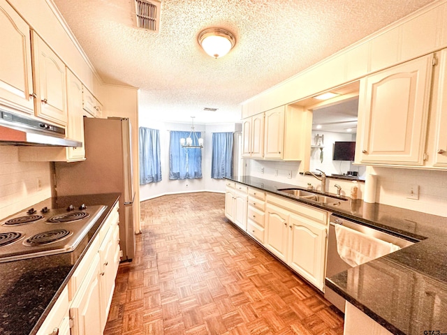 13909 Joe B Fulgham Cir, Brownsboro, TX 75756 - kitchen with a sink, stainless steel appliances, a textured ceiling, a chandelier, and decorative backsplash