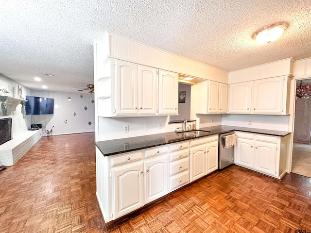 13909 Joe B Fulgham Cir, Brownsboro, TX 75756 - kitchen featuring a sink, stainless steel dishwasher, a textured ceiling, dark countertops, and open floor plan