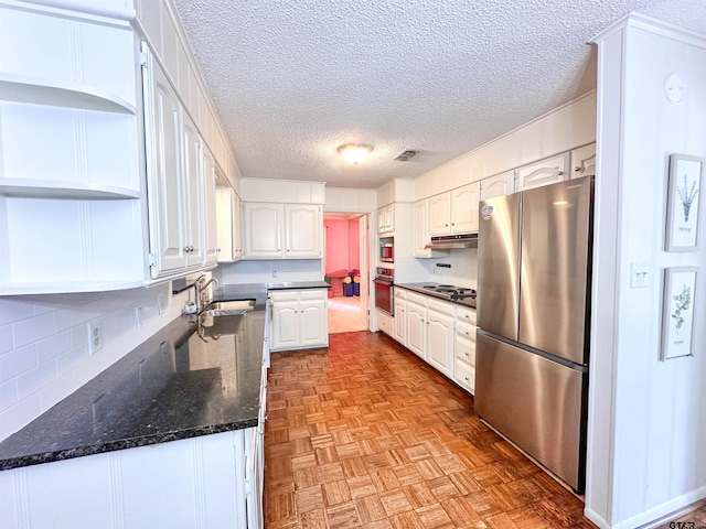 13909 Joe B Fulgham Cir, Brownsboro, TX 75756 - kitchen with freestanding refrigerator, open shelves, under cabinet range hood, white cabinets, and a textured ceiling