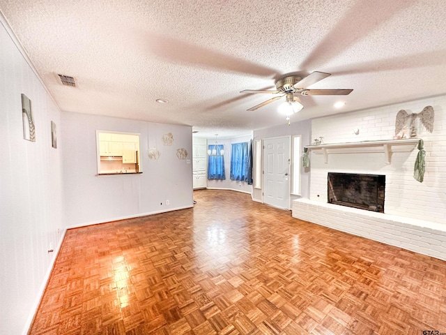 13909 Joe B Fulgham Cir, Brownsboro, TX 75756 - unfurnished living room with baseboards, ceiling fan, a fireplace, and a textured ceiling