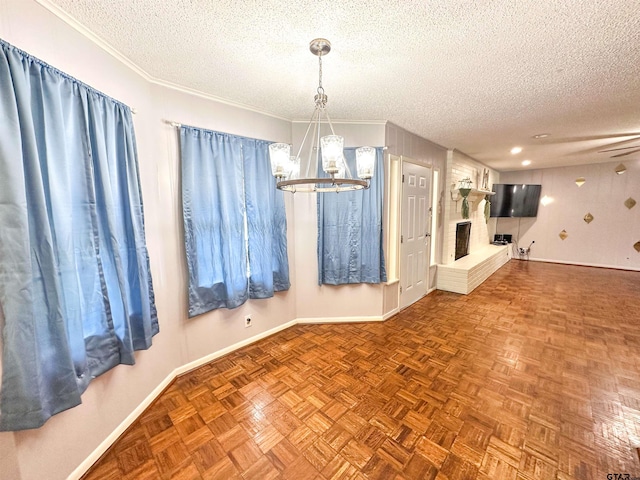 13909 Joe B Fulgham Cir, Brownsboro, TX 75756 - unfurnished dining area with a textured ceiling, a chandelier, a brick fireplace, baseboards, and ornamental molding