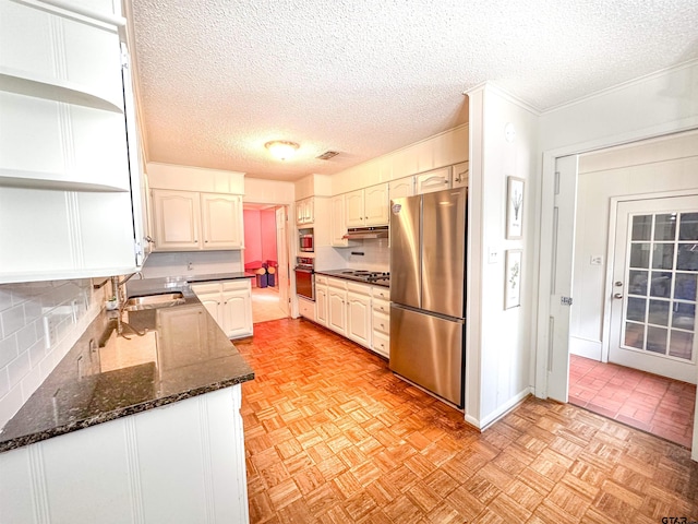 13909 Joe B Fulgham Cir, Brownsboro, TX 75756 - kitchen with freestanding refrigerator, black oven, open shelves, dark stone counters, and tasteful backsplash