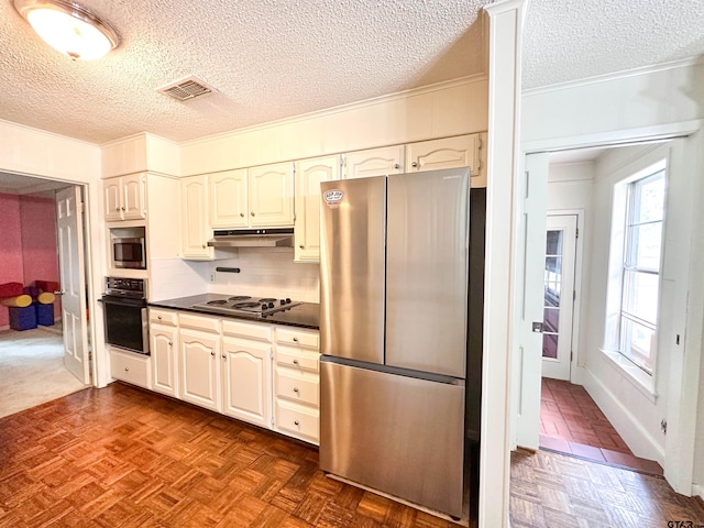 13909 Joe B Fulgham Cir, Brownsboro, TX 75756 - kitchen with appliances with stainless steel finishes, dark countertops, ornamental molding, a textured ceiling, and under cabinet range hood