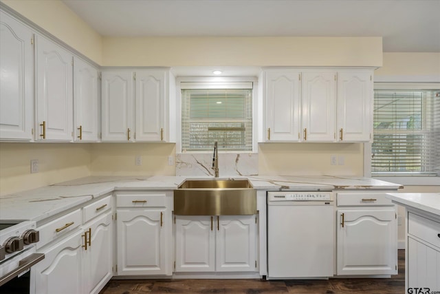 kitchen featuring sink, white dishwasher, white cabinetry, light stone countertops, and range