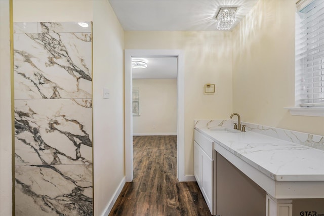 bathroom with hardwood / wood-style floors, vanity, and a notable chandelier