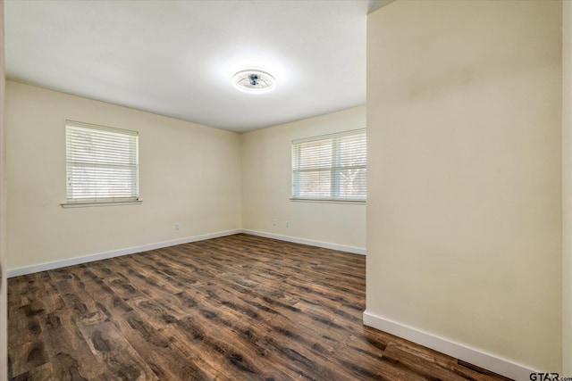 unfurnished room with dark hardwood / wood-style floors