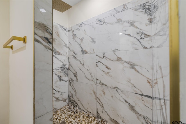 bathroom with a tile shower