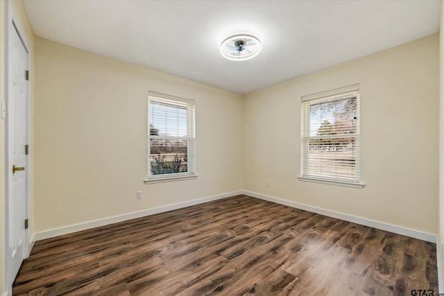 unfurnished room featuring dark wood-type flooring