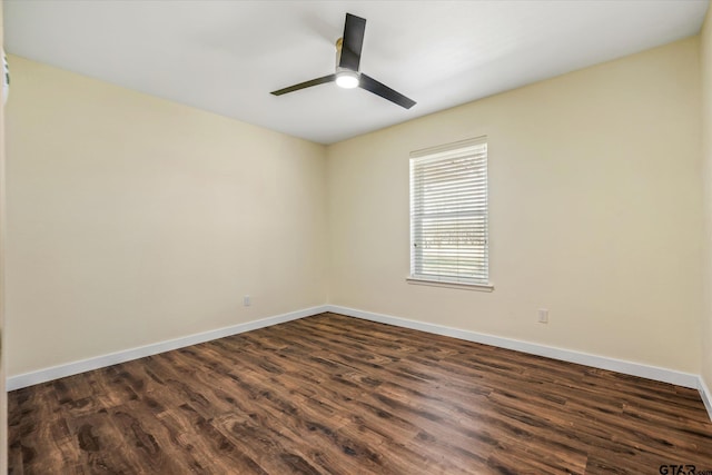 empty room with ceiling fan and dark hardwood / wood-style floors