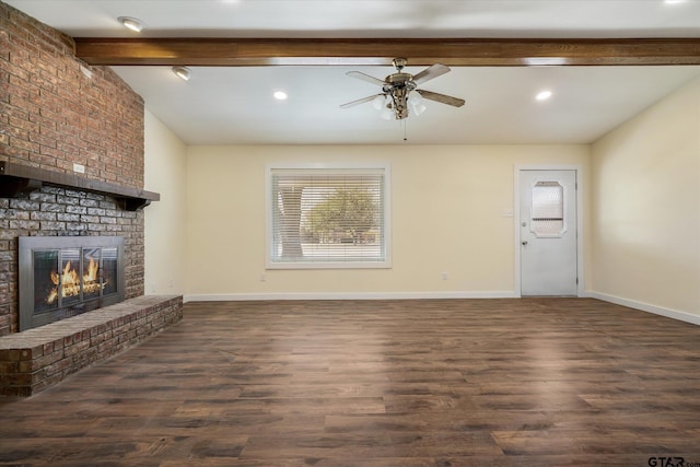 unfurnished living room with beam ceiling, ceiling fan, dark hardwood / wood-style flooring, and a fireplace