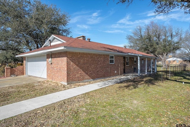 view of side of property with a yard and a garage