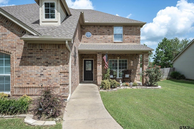 view of front of house with covered porch and a front yard