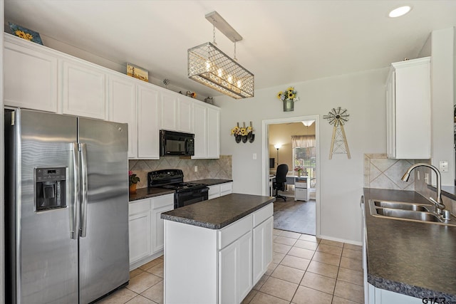 kitchen featuring white cabinetry, sink, decorative light fixtures, a kitchen island, and black appliances