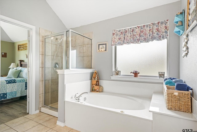 bathroom with plus walk in shower, hardwood / wood-style flooring, and vaulted ceiling