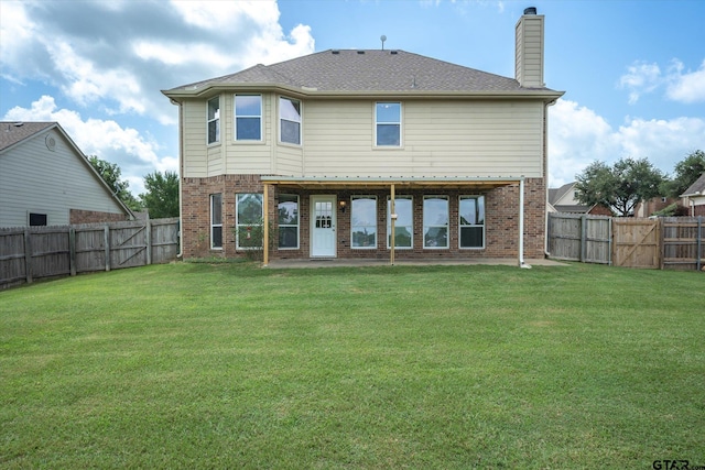 rear view of house with a yard