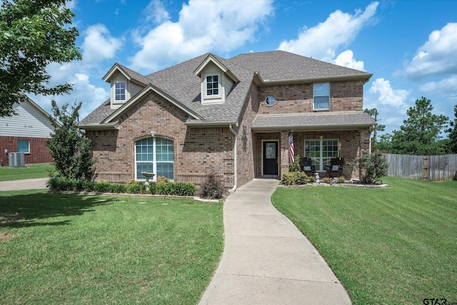 view of front of home featuring a front lawn and cooling unit