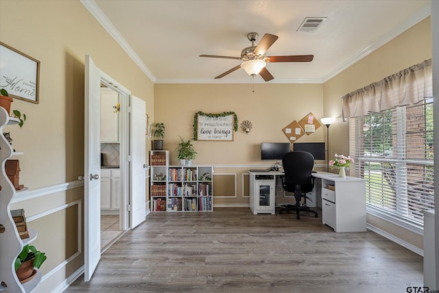 office space with light wood-type flooring, ceiling fan, and ornamental molding