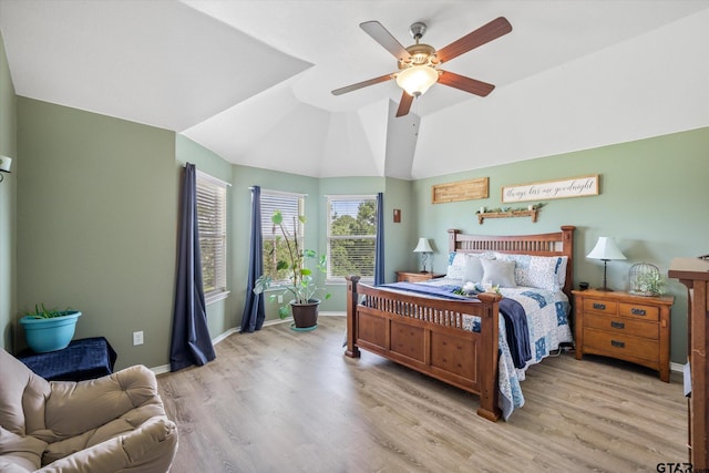 bedroom featuring ceiling fan, light hardwood / wood-style floors, and lofted ceiling