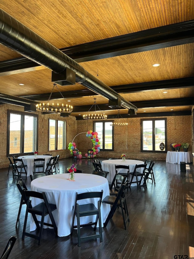 dining space with beam ceiling, wooden ceiling, dark hardwood / wood-style floors, and brick wall
