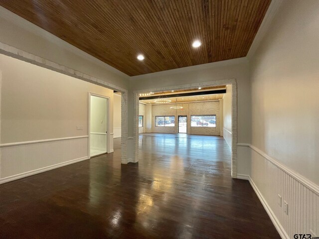 empty room featuring dark hardwood / wood-style flooring and wood ceiling