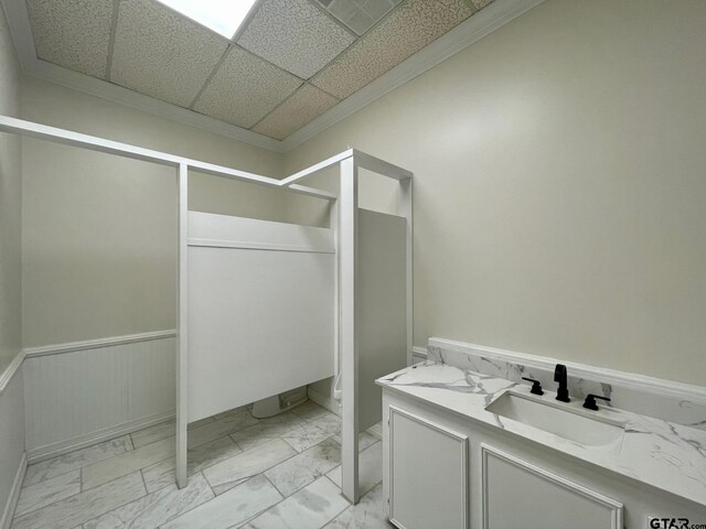 bathroom with a paneled ceiling and vanity