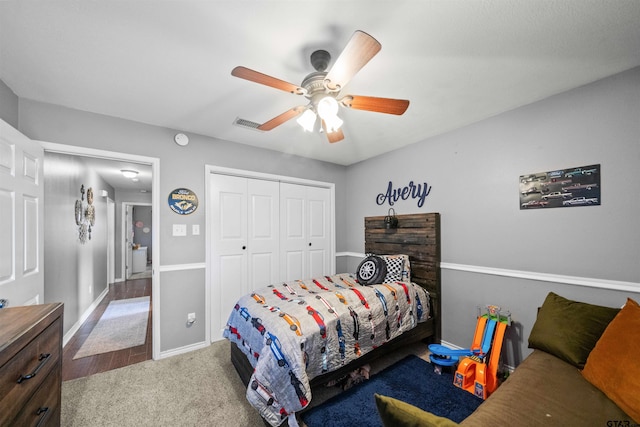 bedroom with carpet, a closet, visible vents, a ceiling fan, and baseboards