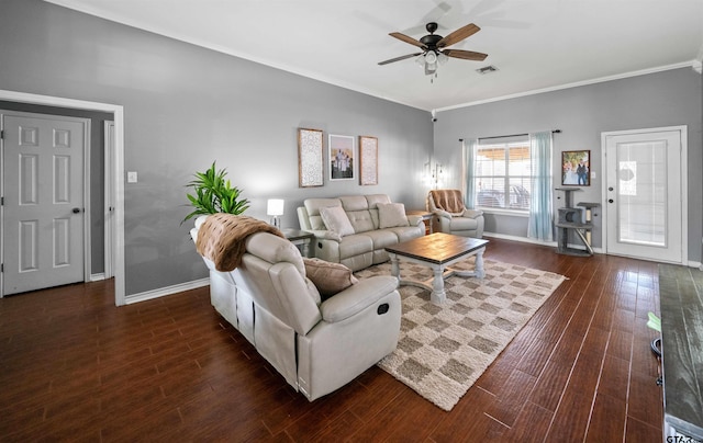 living area featuring a ceiling fan, crown molding, baseboards, and wood finished floors